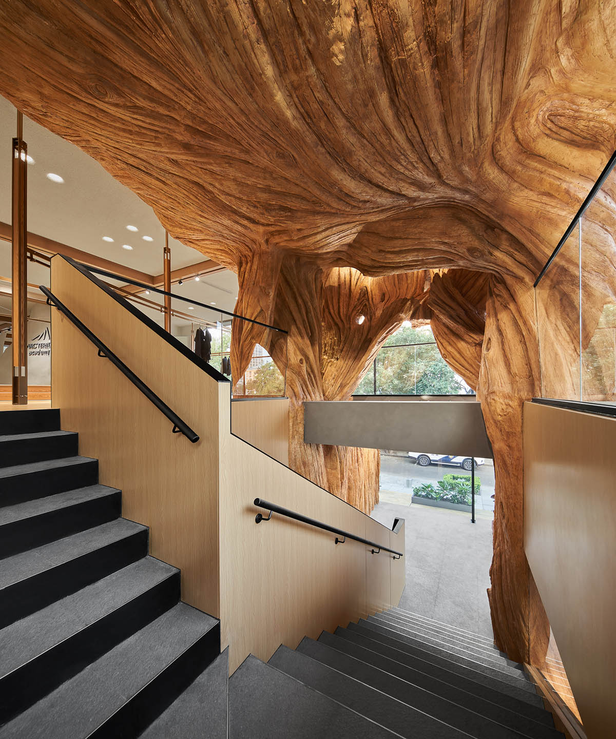 STILL YOUNG creates cave-like interiors for a store with wood and rock elements in Beijing 