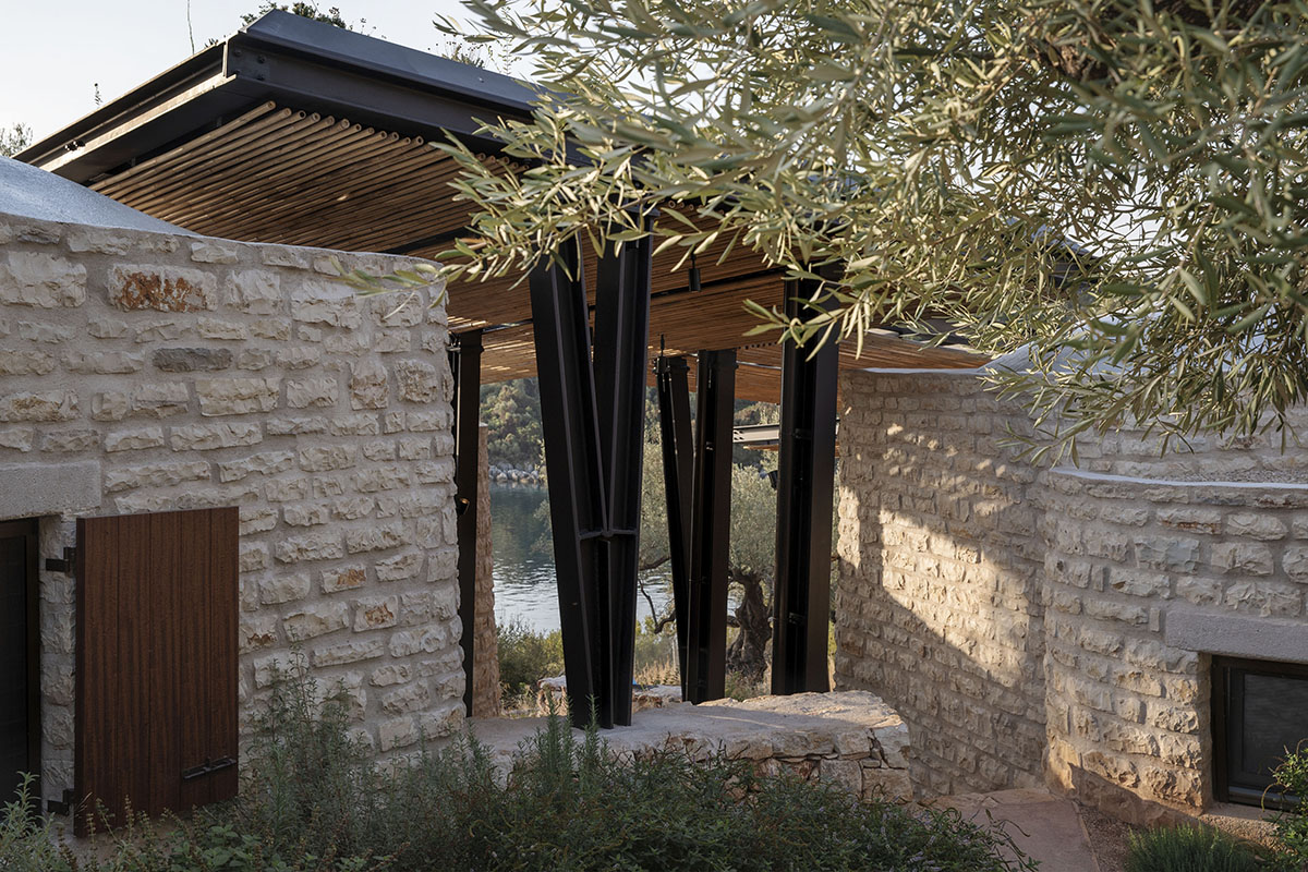 Pastoral round stone dwellings inform Meganisi House by Hiboux Architecture on Meganisi island