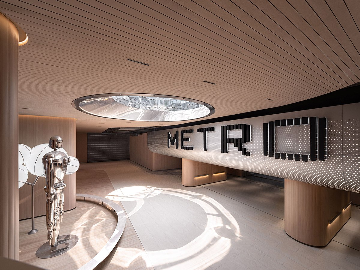TOMO Design creates interiors for metro station with soft wood hues and circular light strip