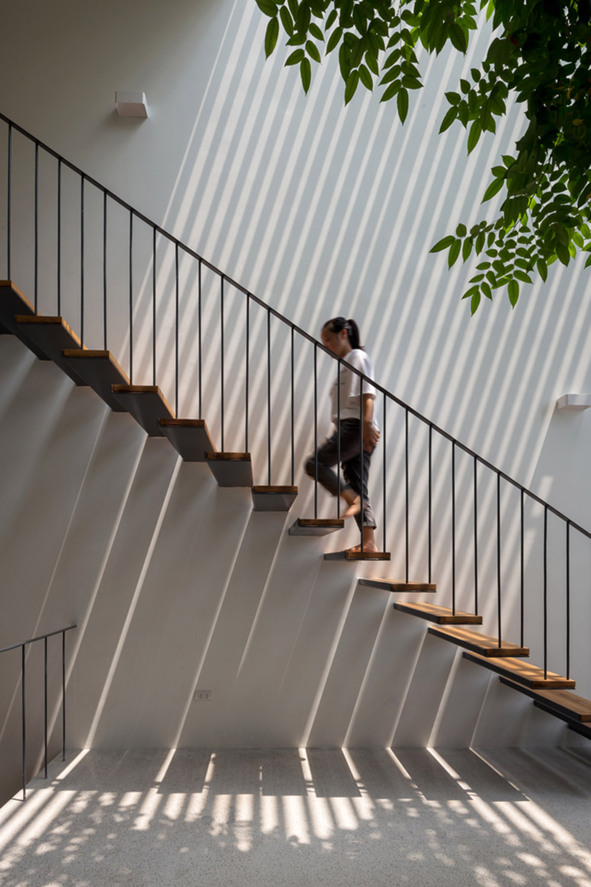 ODDO architects built this narrow house with rich interior spaces and perforated skin in Hanoi