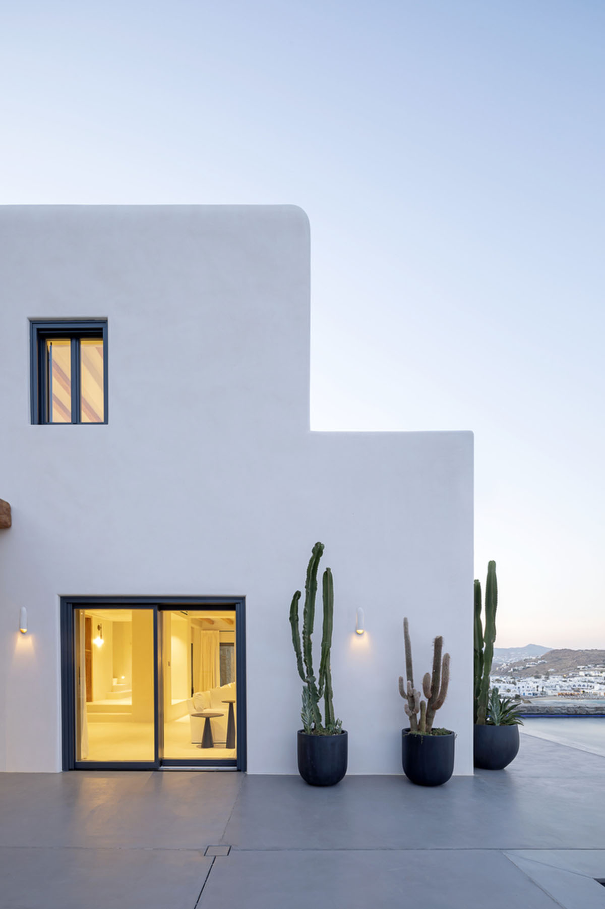 MK Design Studio designs luxurious holiday villa with creamy white walls and stone-walled terraces