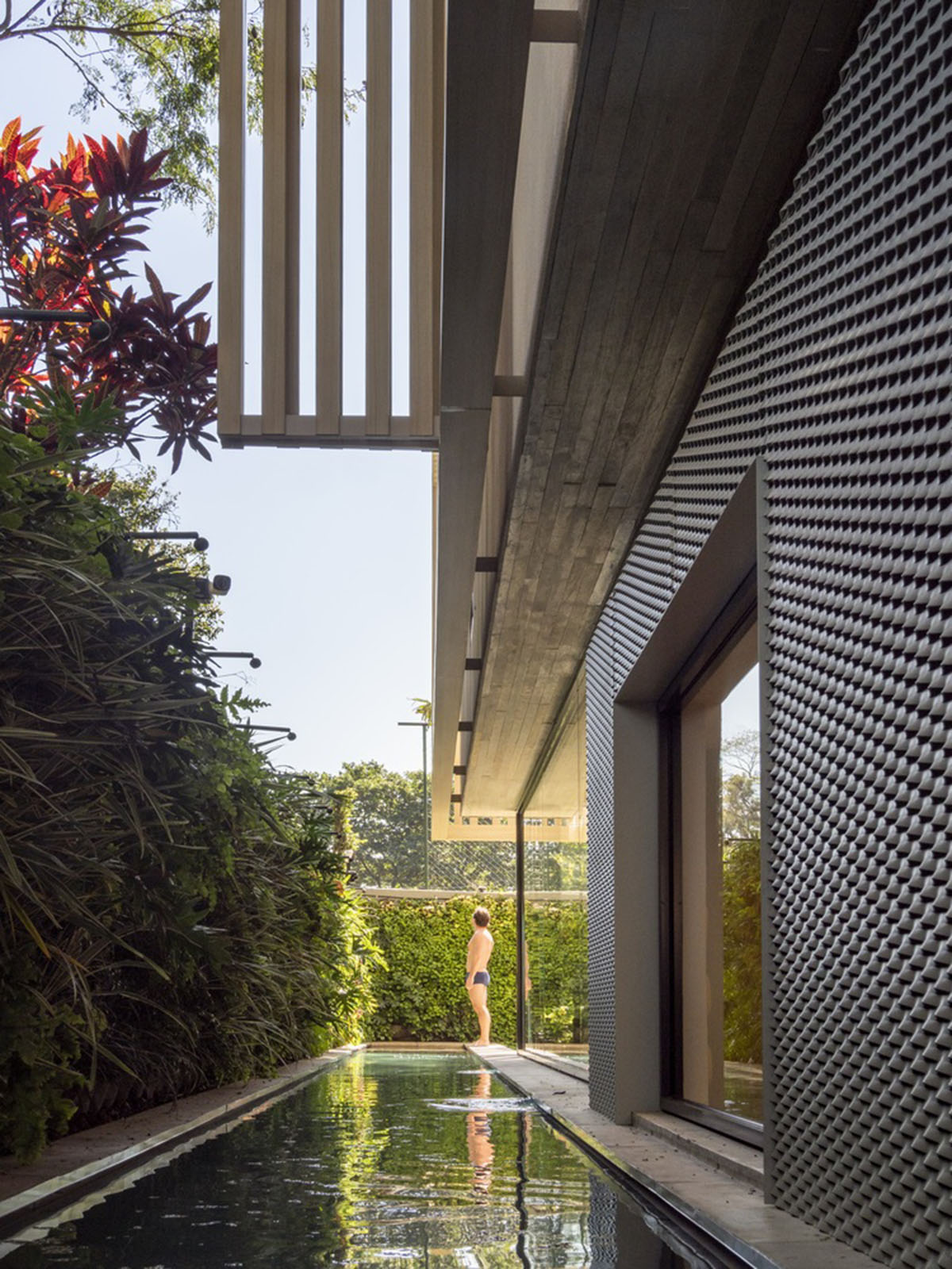 Studio AG designed large wooden residence featuring punctured volumes with gabled roof in São Paulo