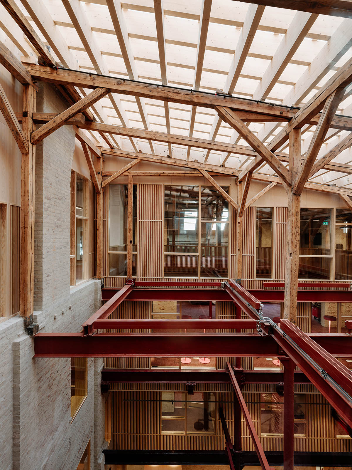 Atelier Oslo and KIMA Arkitektur restore former warehouse as a press house with light-lit atrium