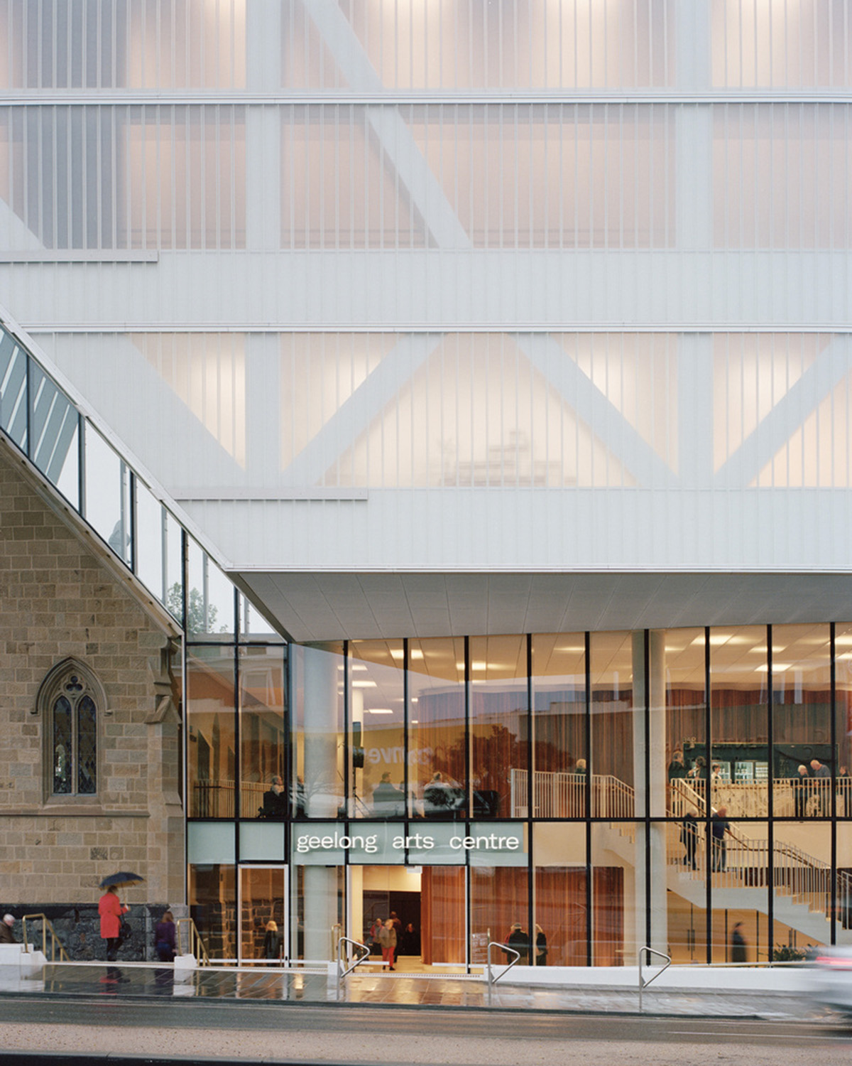Hassell reveals Arts Centre with sliced translucent volume which is in dialogue with historic church