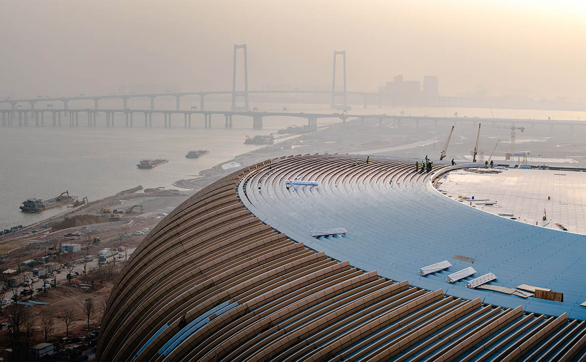 ZHA's Greater Bay Area Sports Centre, featuring distinctive layered roof, nears completion in China