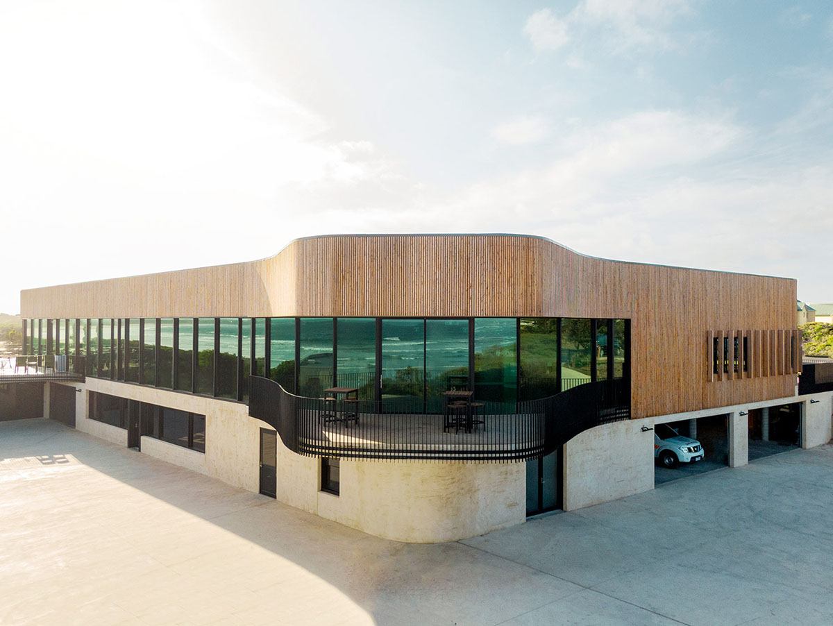 Wood Marsh completes surf club with timber rounded corners echoing ocean and eroded dunes