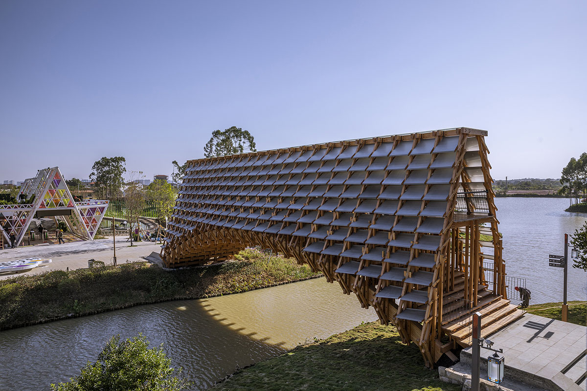 Arched timber bridge by LUO studio allows boats to pass under bridge smoothly in Gulou waterfront