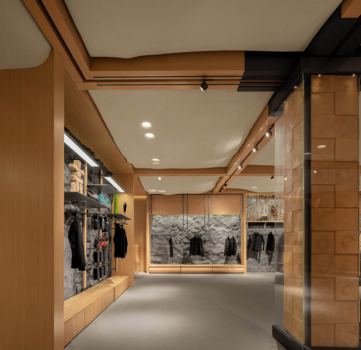 STILL YOUNG creates cave-like interiors for a store with wood and rock elements in Beijing 