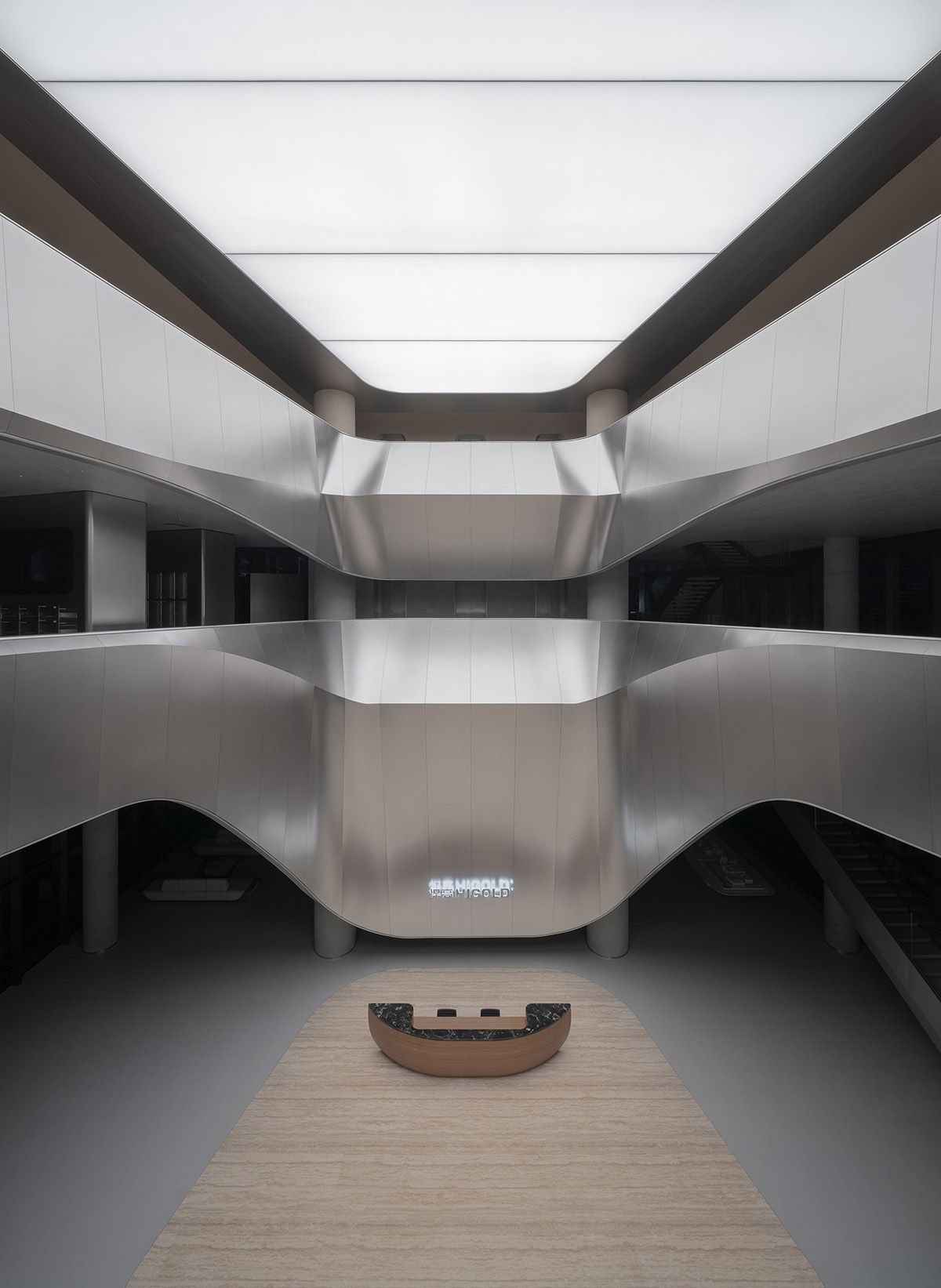 E Studio takes visitors into space travel with a flow of sculpted stainless steel for a showroom