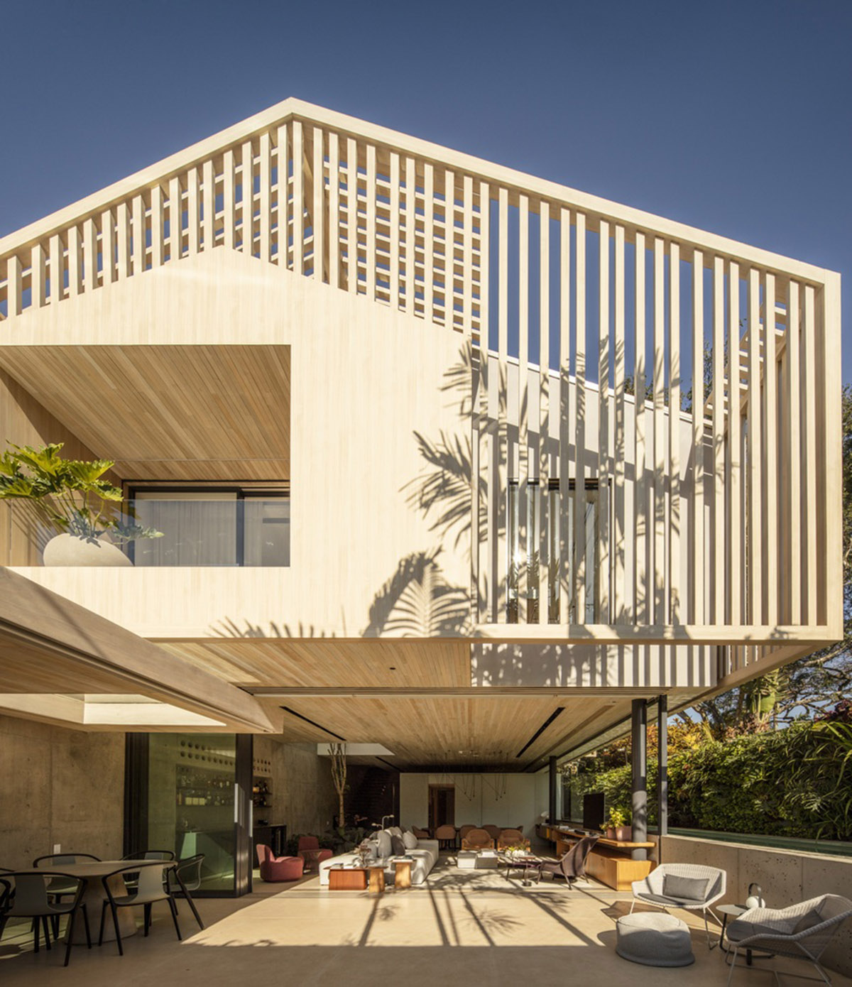 Studio AG designed large wooden residence featuring punctured volumes with gabled roof in São Paulo