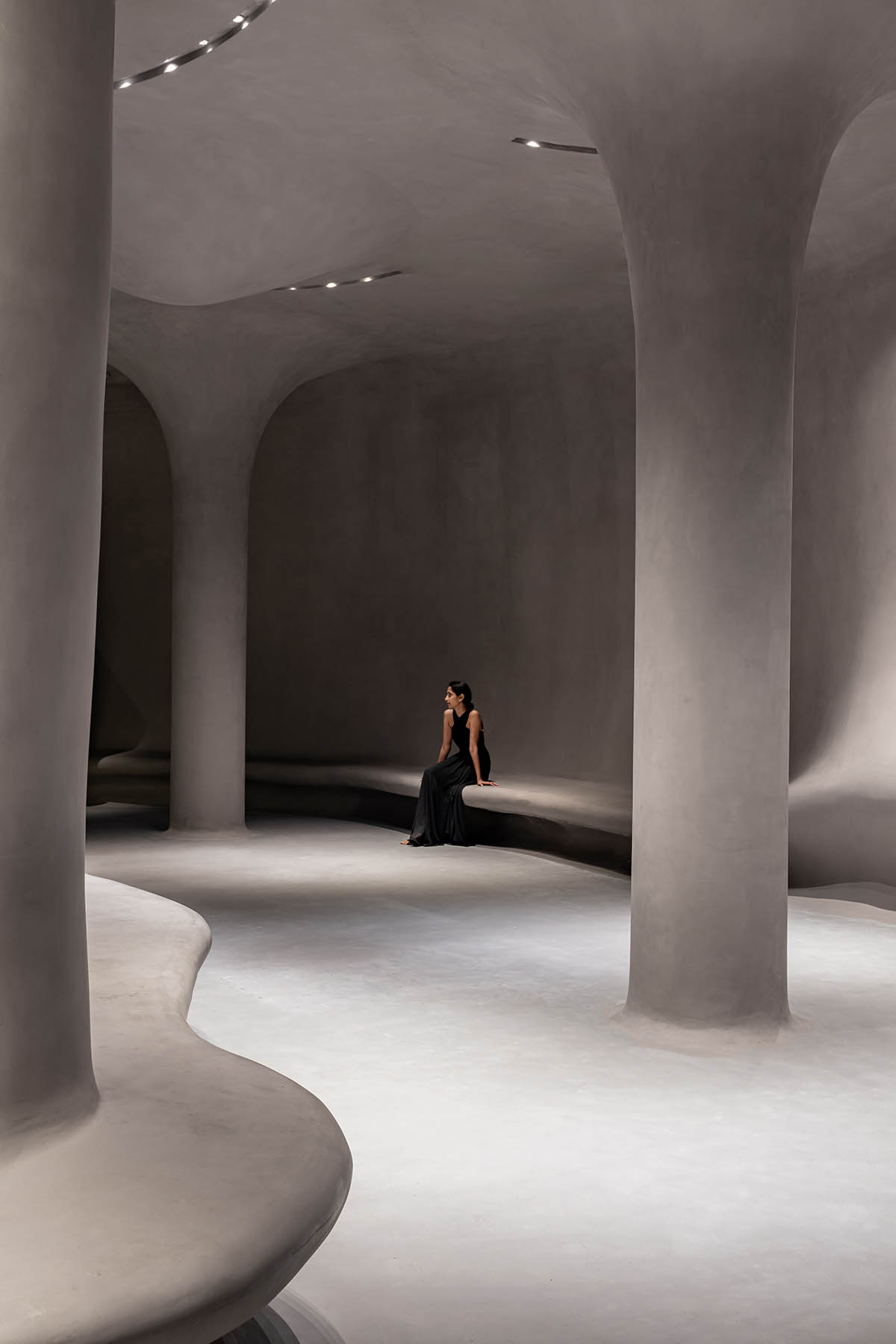 Grey fluid concrete wraps Aatma Manthan Museum by Sanjay Puri Architects