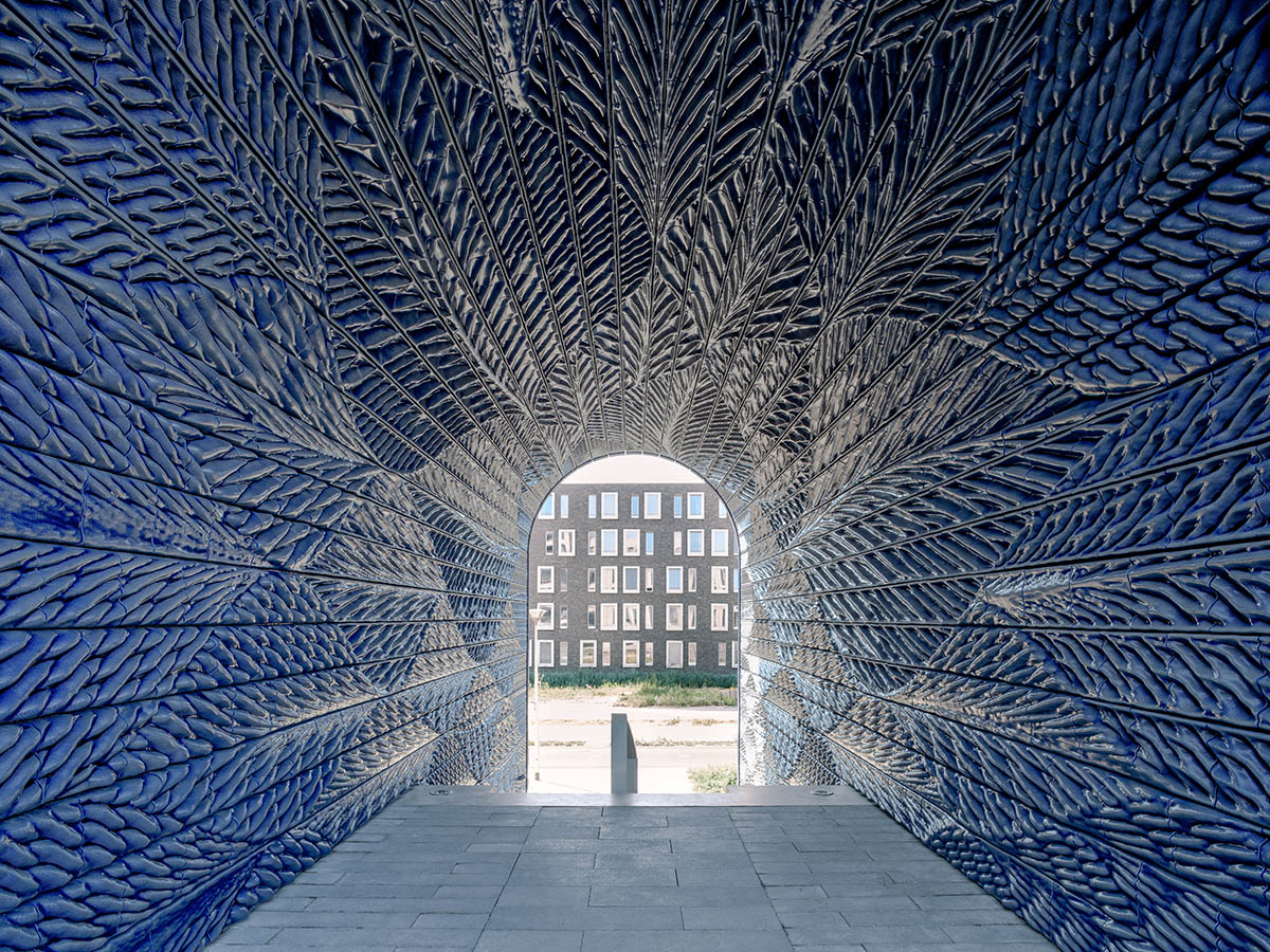 Studio RAP clads two gates of PoortMeesters residential building block in 3D blue porcelain