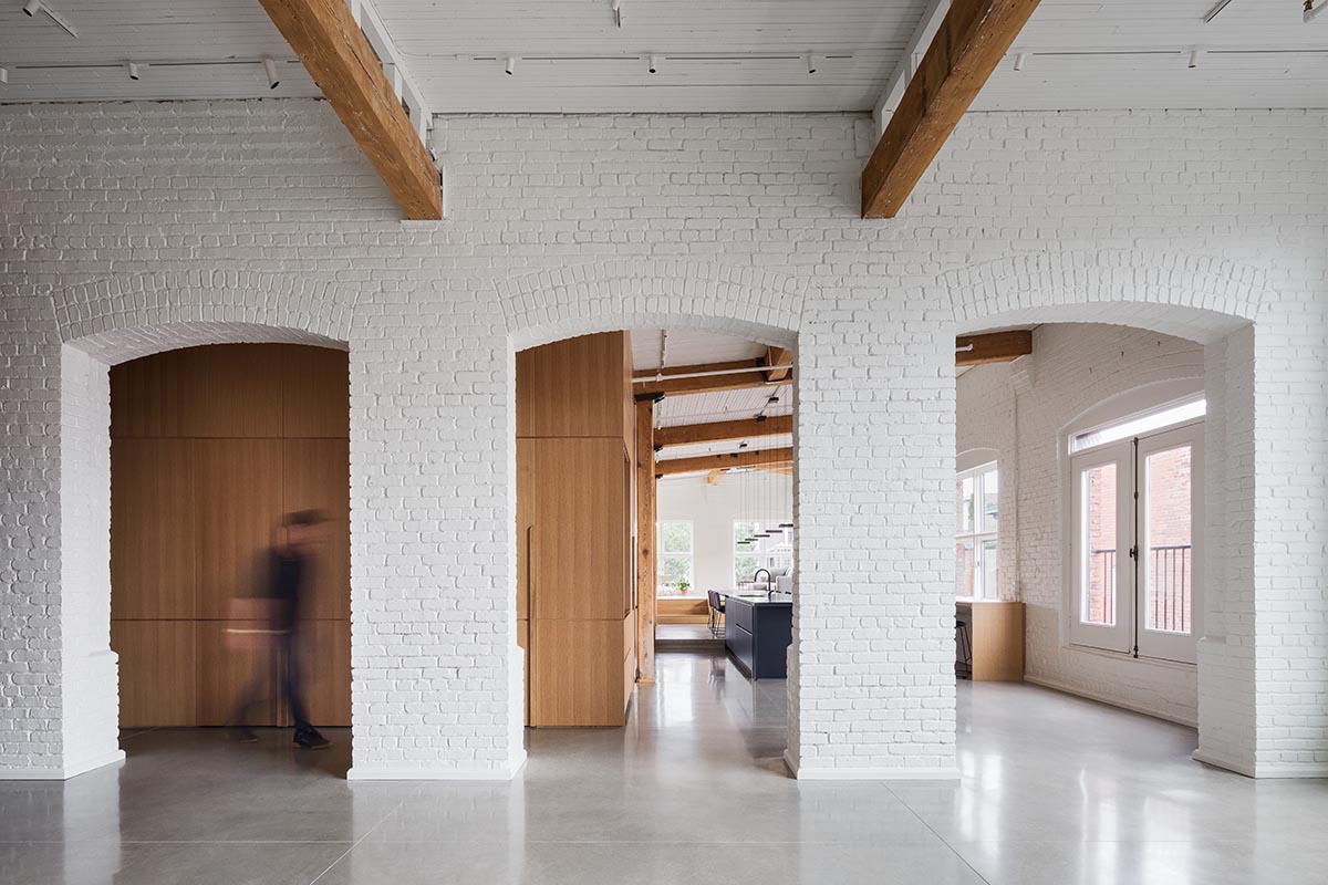 La Firme renovates historic mid-19th-century building with brick walls and oak cabinets in Montreal 