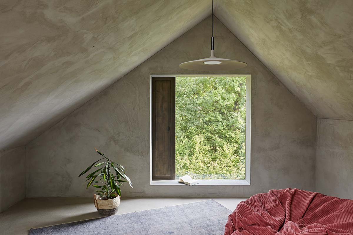 Residential barn features an unfinished, raw interior in Swiss rural landscape