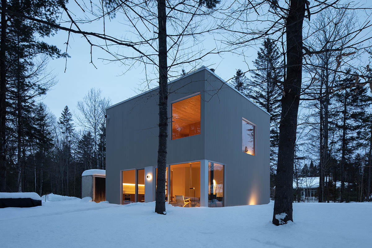 Maurice Martel Architecte creates 'almost perfect cube' for wintery chalet in a lush forest