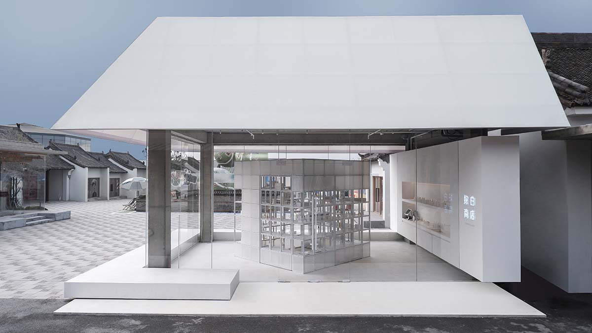 A shop is attached to Beijing historic Hutong houses with white-colored skin