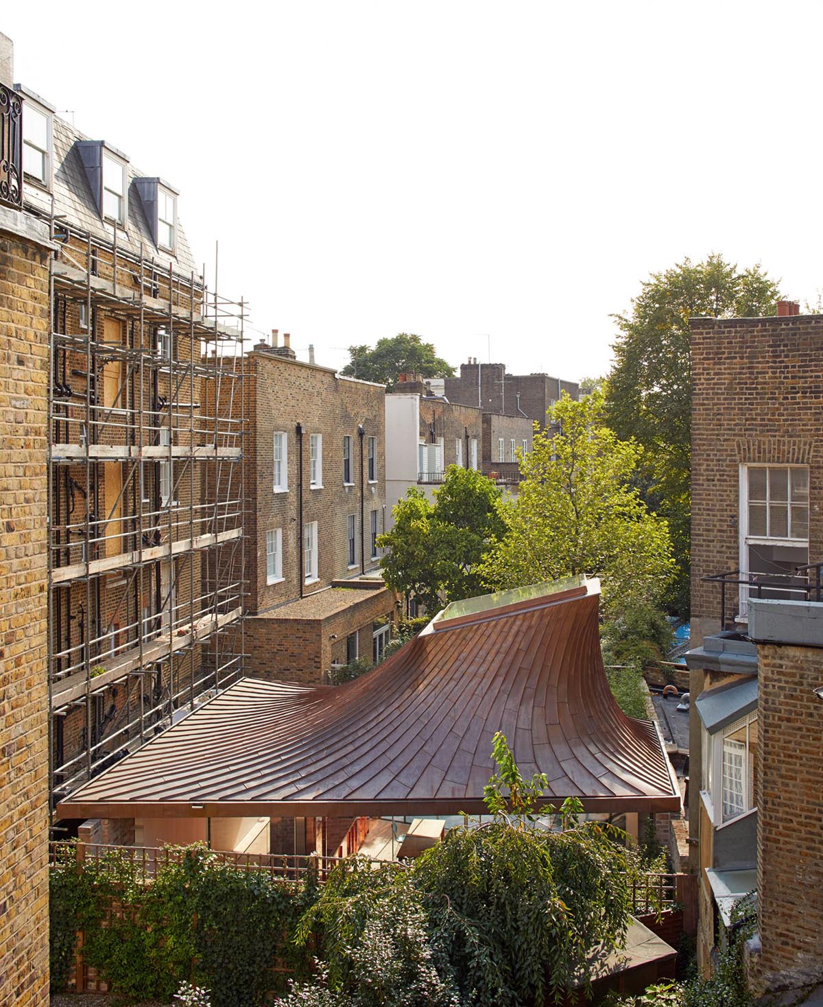 Gianni Botsford Architects transforms dilapidated bungalow with a giant copper clad roof in London