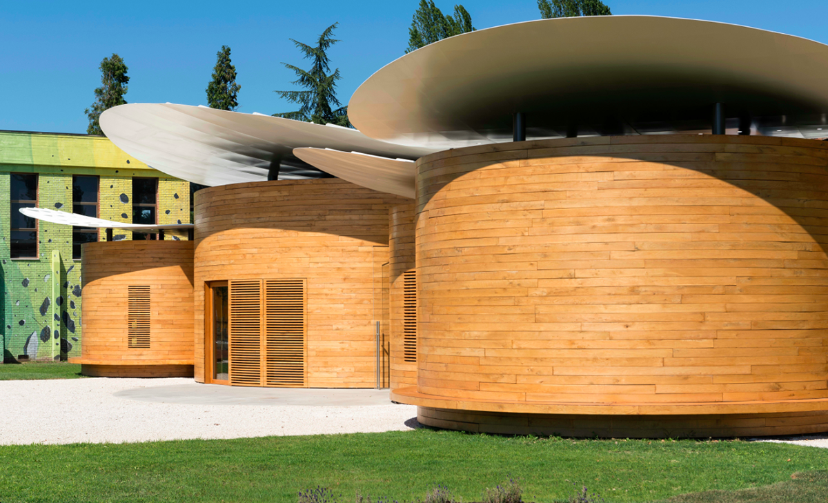 Nine wooden circular music boxes by MCA placed on the former Lamborghini manufacturing site in Italy