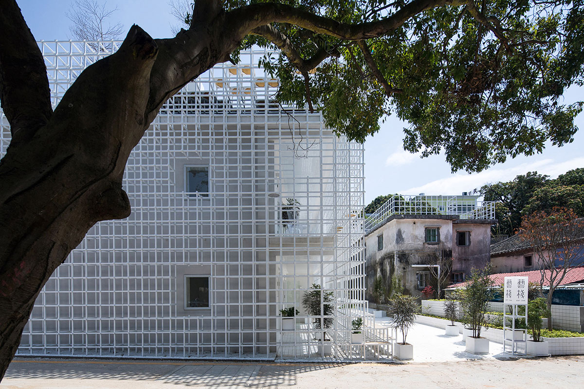 Aether Architects converted old village house into a local hostel by wrapping with structural lattice