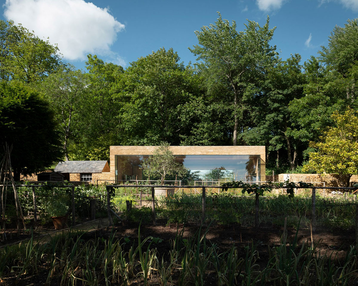 Invisible Studio creates large window for a gymnasium overlooking to a productive garden in Somerset