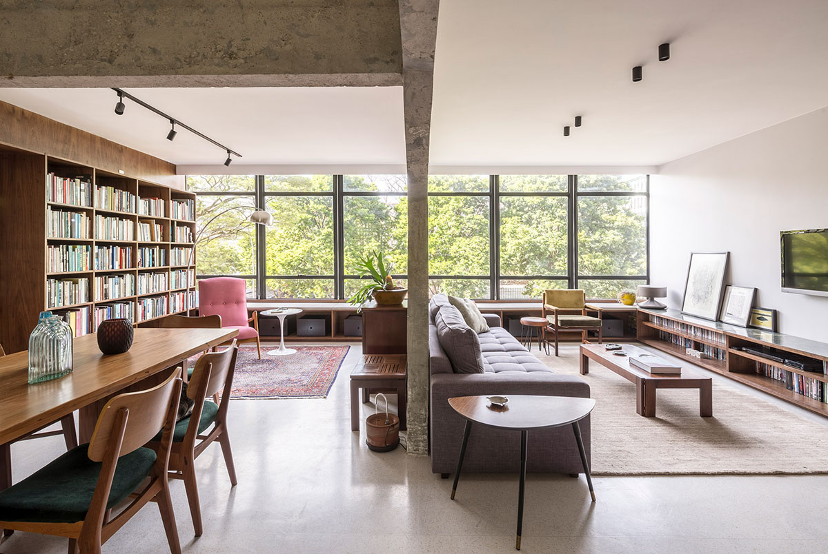 A historic Brazilian apartment has been redesigned with wooden bookcase as main divider