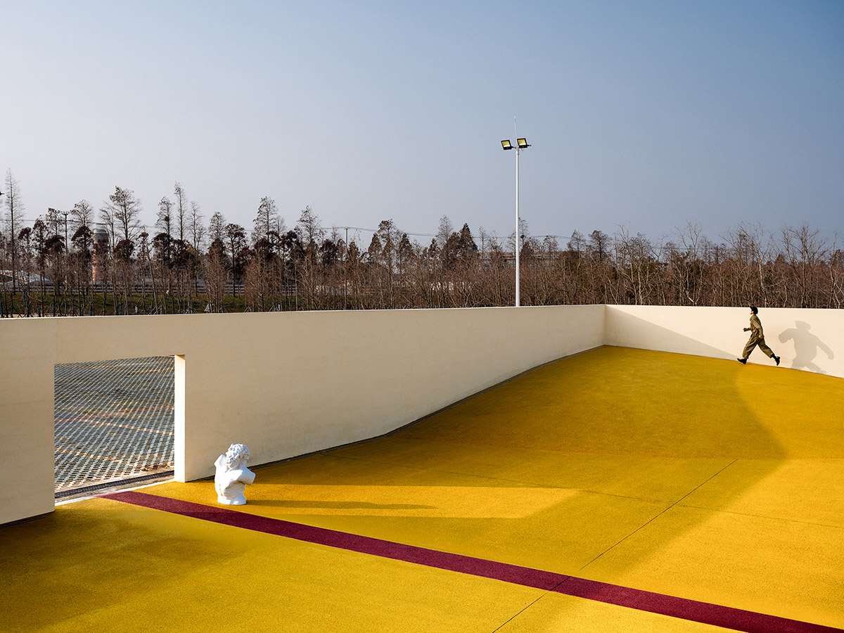 Wutopia Lab converts abandoned barnyard into a golden yellow field resembling a frozen harvest time