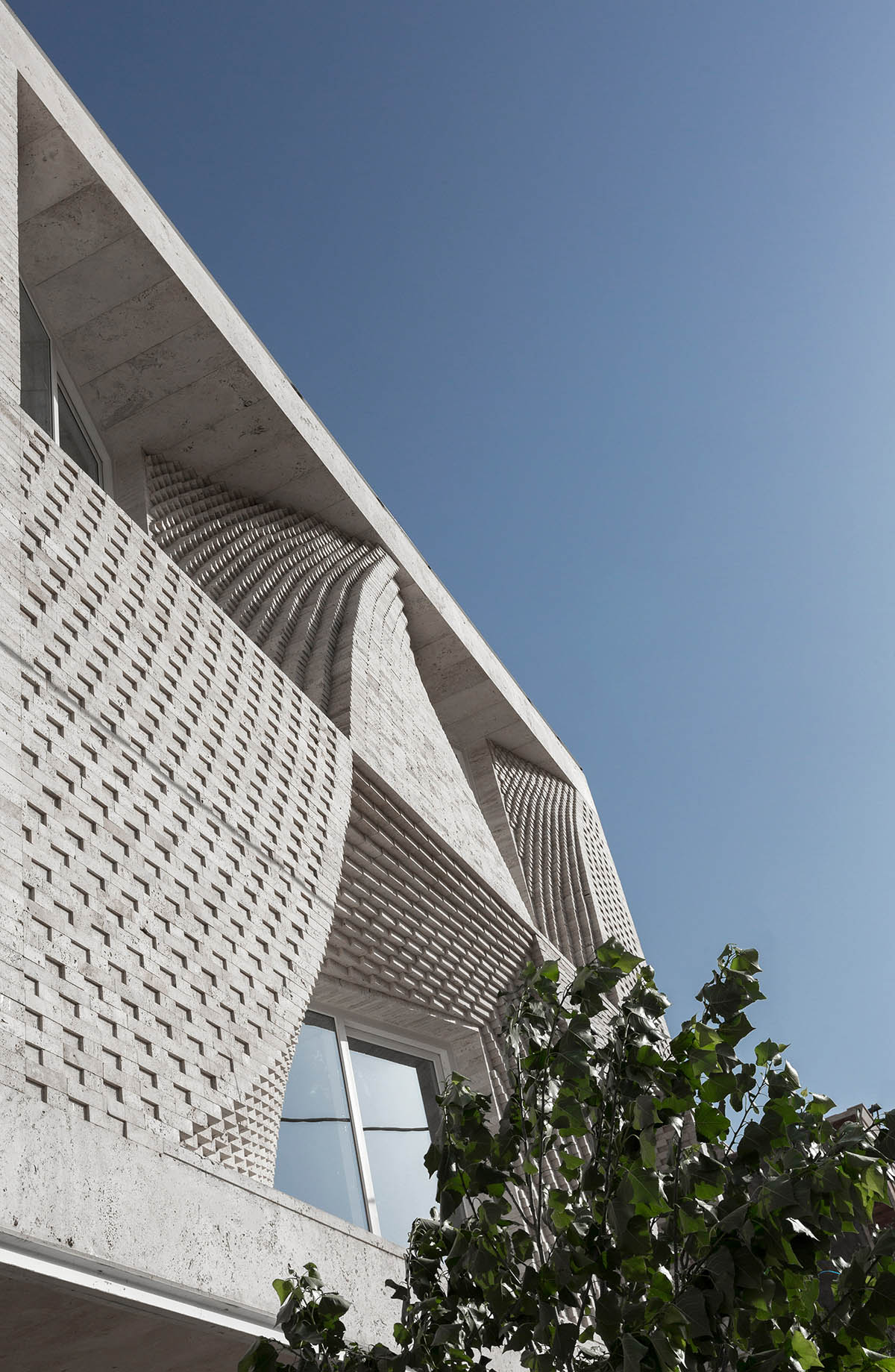 CAAT Studio creates spatial variations of stone on the facade of this Iranian residential building