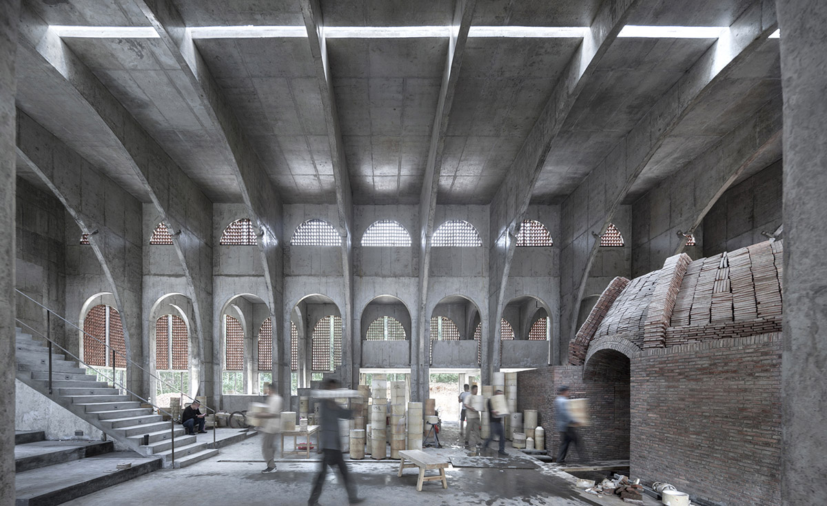 AZL Architects renovates old kiln building with concrete and brick arches in the middle of a forest