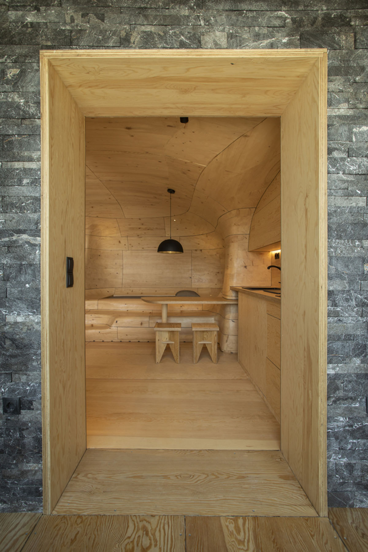 Tenon Architecture creates cave-like wooden interior for a resort in Greece