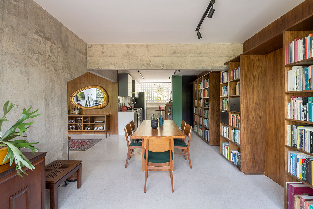A historic Brazilian apartment has been redesigned with wooden bookcase as main divider