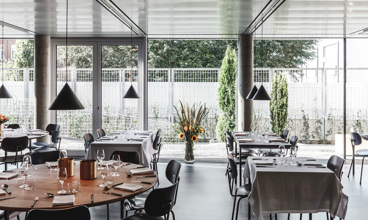 A collage of elements reflecting surroundings assembled on the facade of Office Building by SLETH