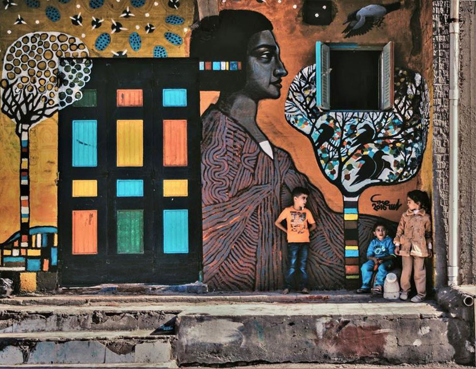 Mona Hassan captures Egyptian Village Festival Houses composed of colourful paintings by 40 artists