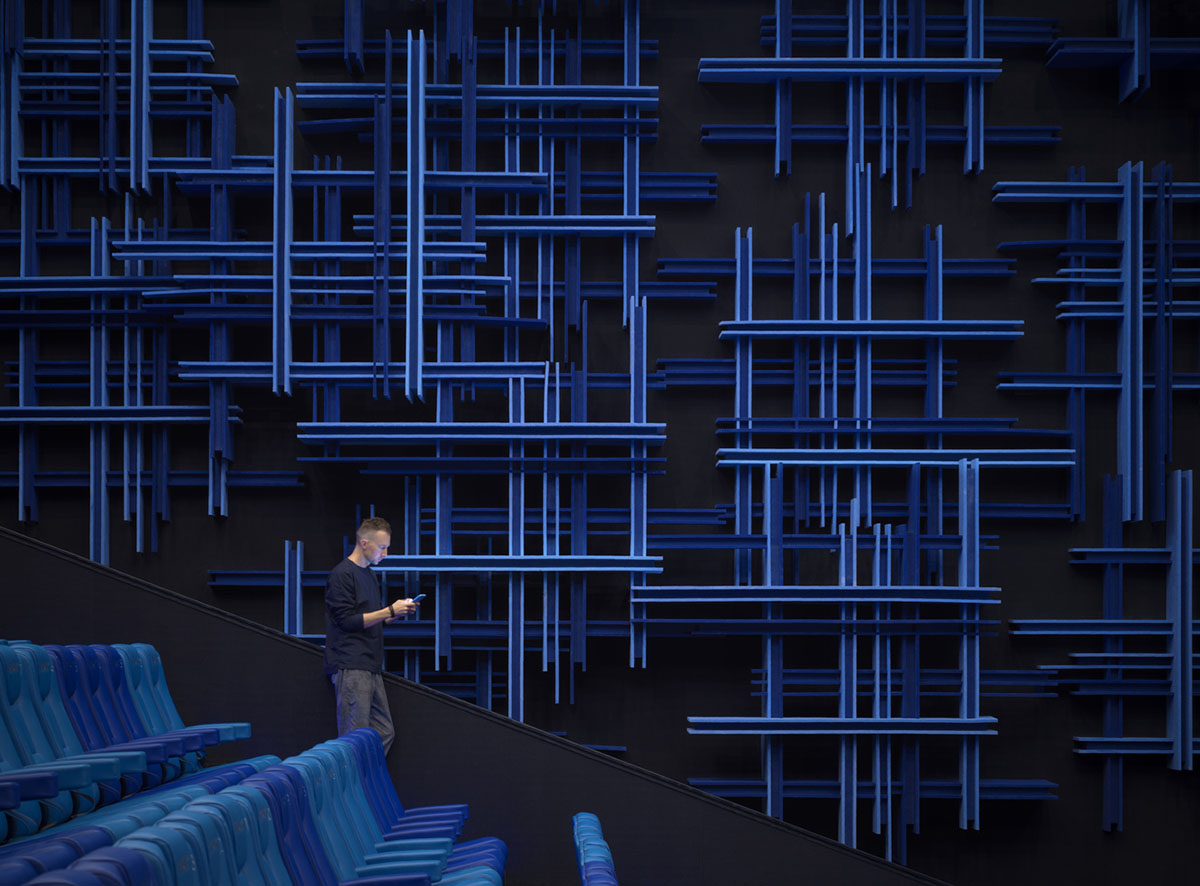 One Plus Partnership enhances depth of interior space with blue metal bars for a Cinema in Shenzhen