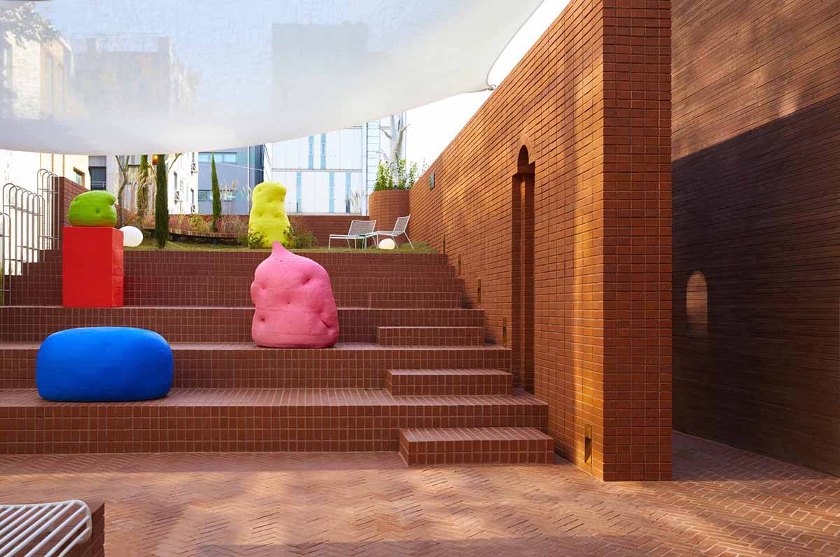 Roly-Poly Cotto restaurant fills in between historic buildings with its cave-like red brick facade