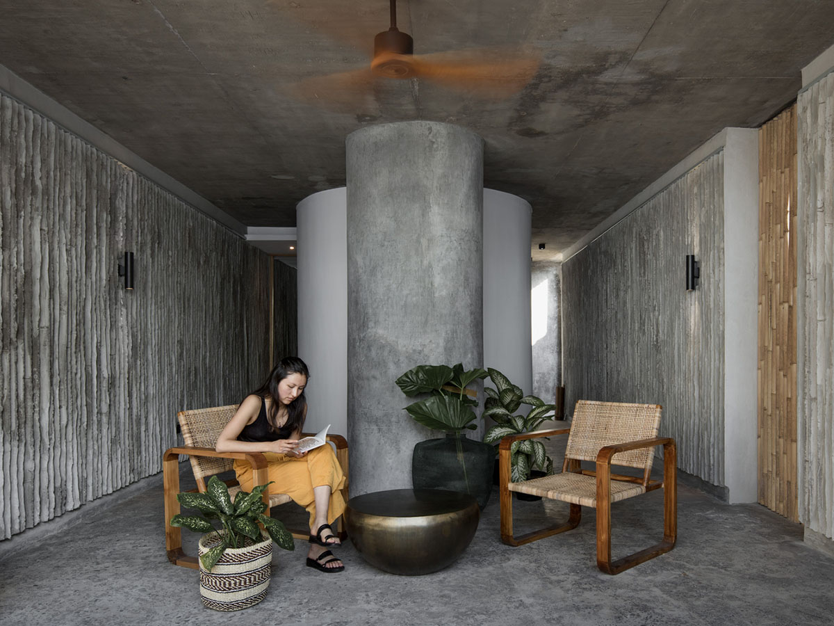 Linear concrete walls hide hotel rooms overlooking lush forest on the northern coast of Bali