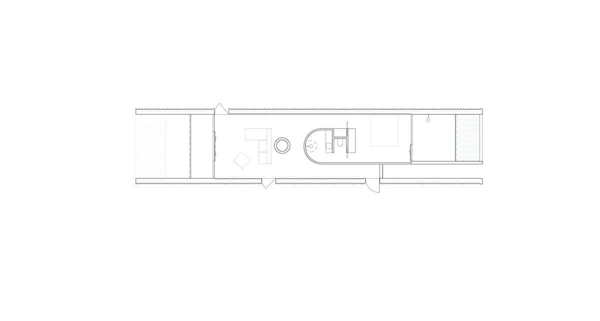 Linear concrete walls hide hotel rooms overlooking lush forest on the northern coast of Bali