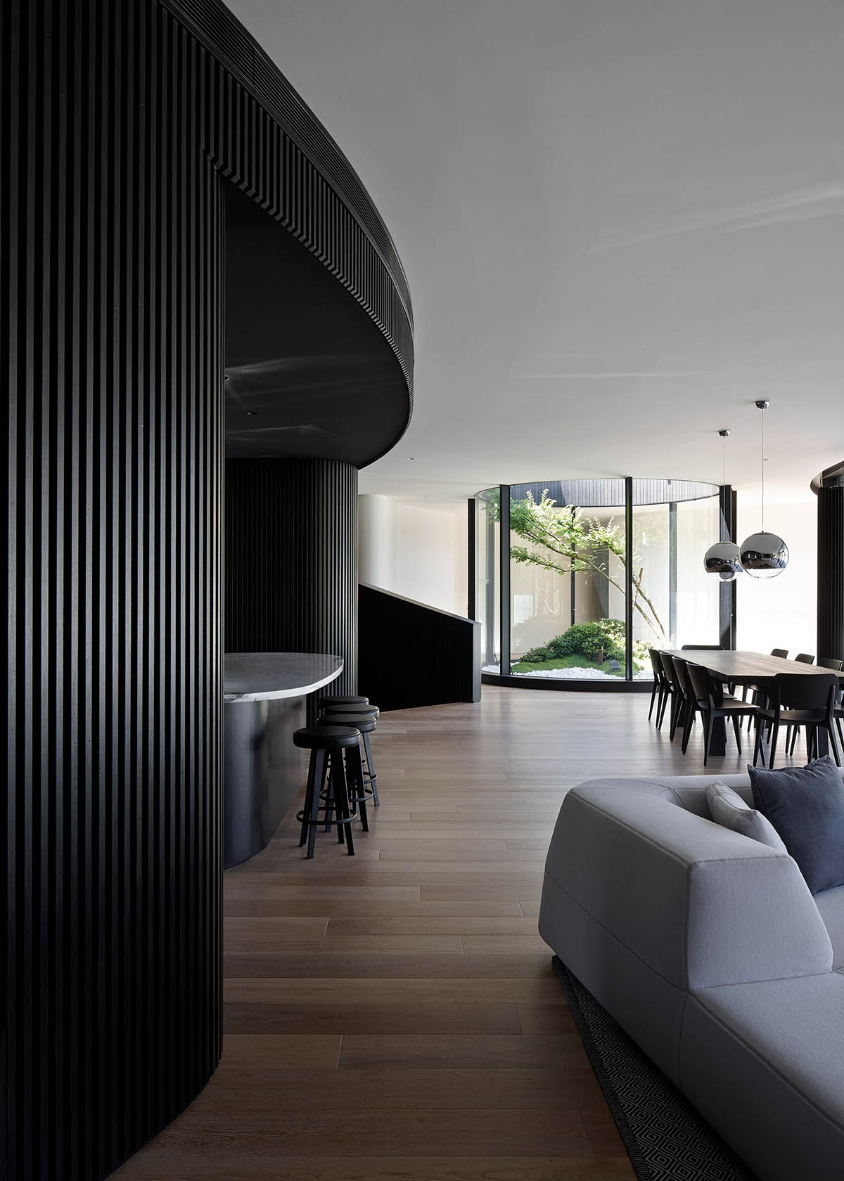 Wood Marsh built curvaceous home clad in dark timber contrasting its natural landscape in Portsea