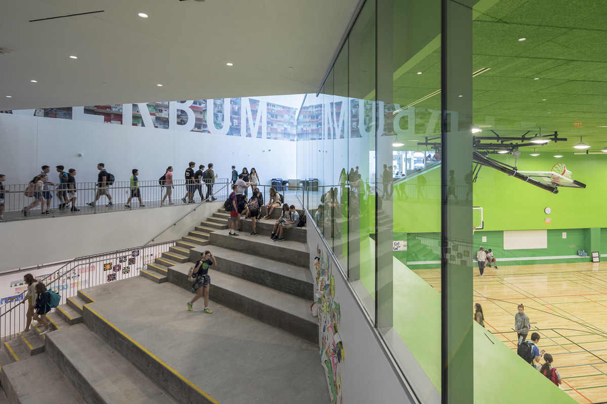 Five rectangular volumes rotating around a fixed pivot point form BIG-designed educational building