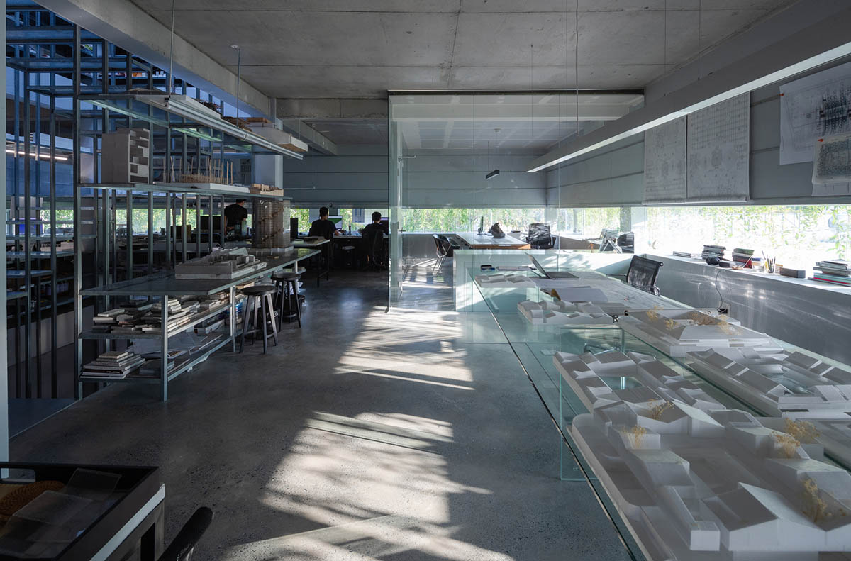 MIA Design Studio created vertical open library inside its office filled with greenery in Vietnam