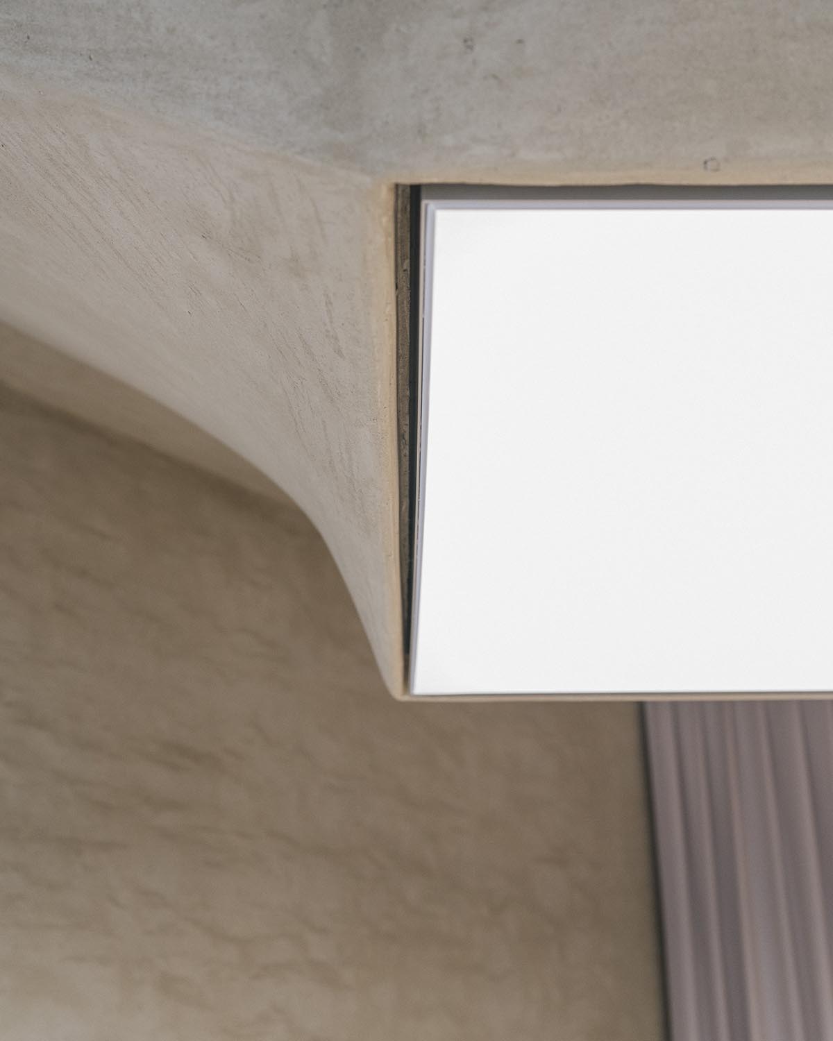 The interior of a workshop brings a zenithal light with the potter's wheel-like ceiling