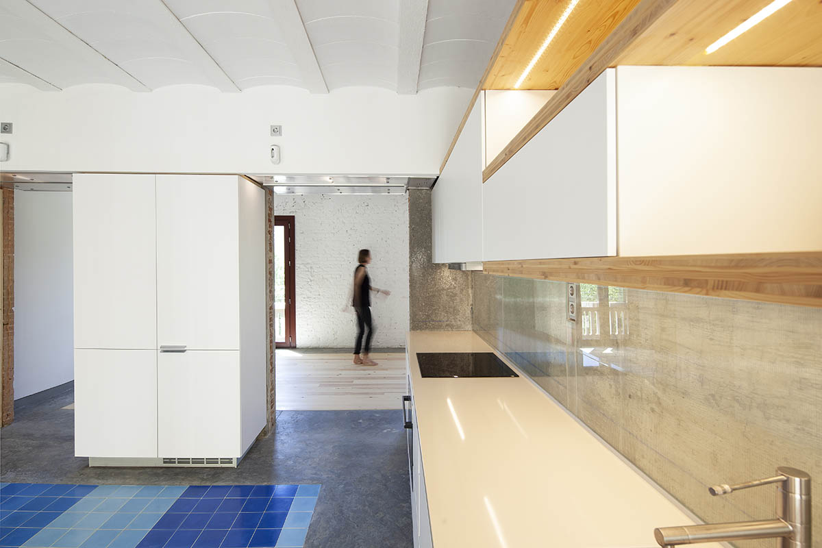 La Carboneria housing block features a dramatic courtyard with crossing beams in Barcelona