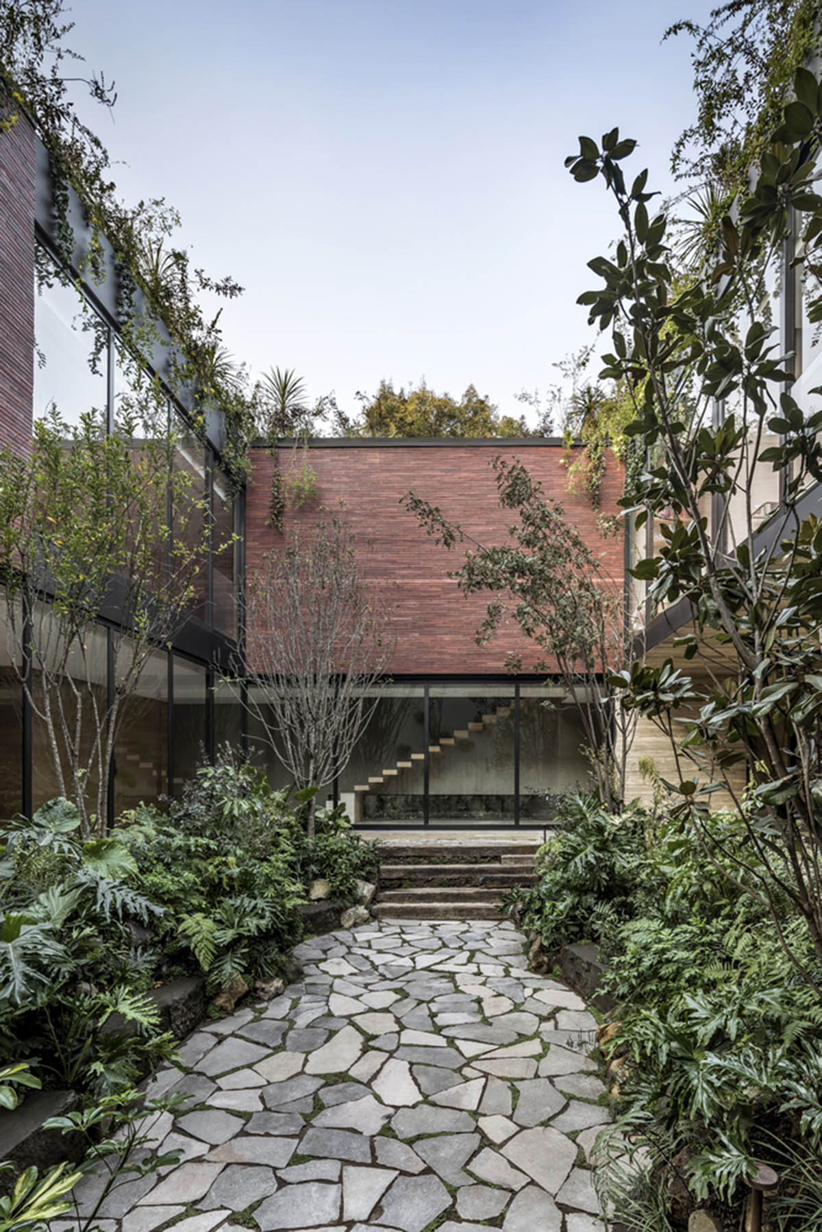 ESRAWE designs house by using red brick pavilion-like volumes in Mexico City