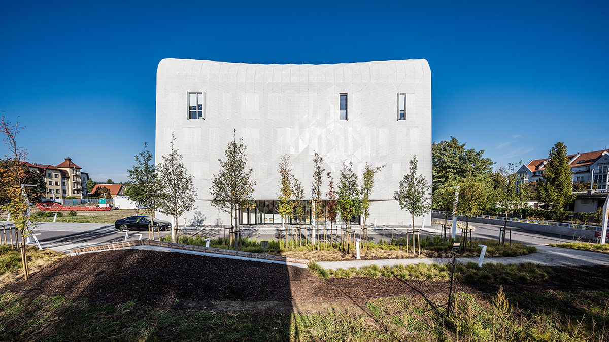 FAAB wraps research center with white perforated facade evoking sea waves in Poland 