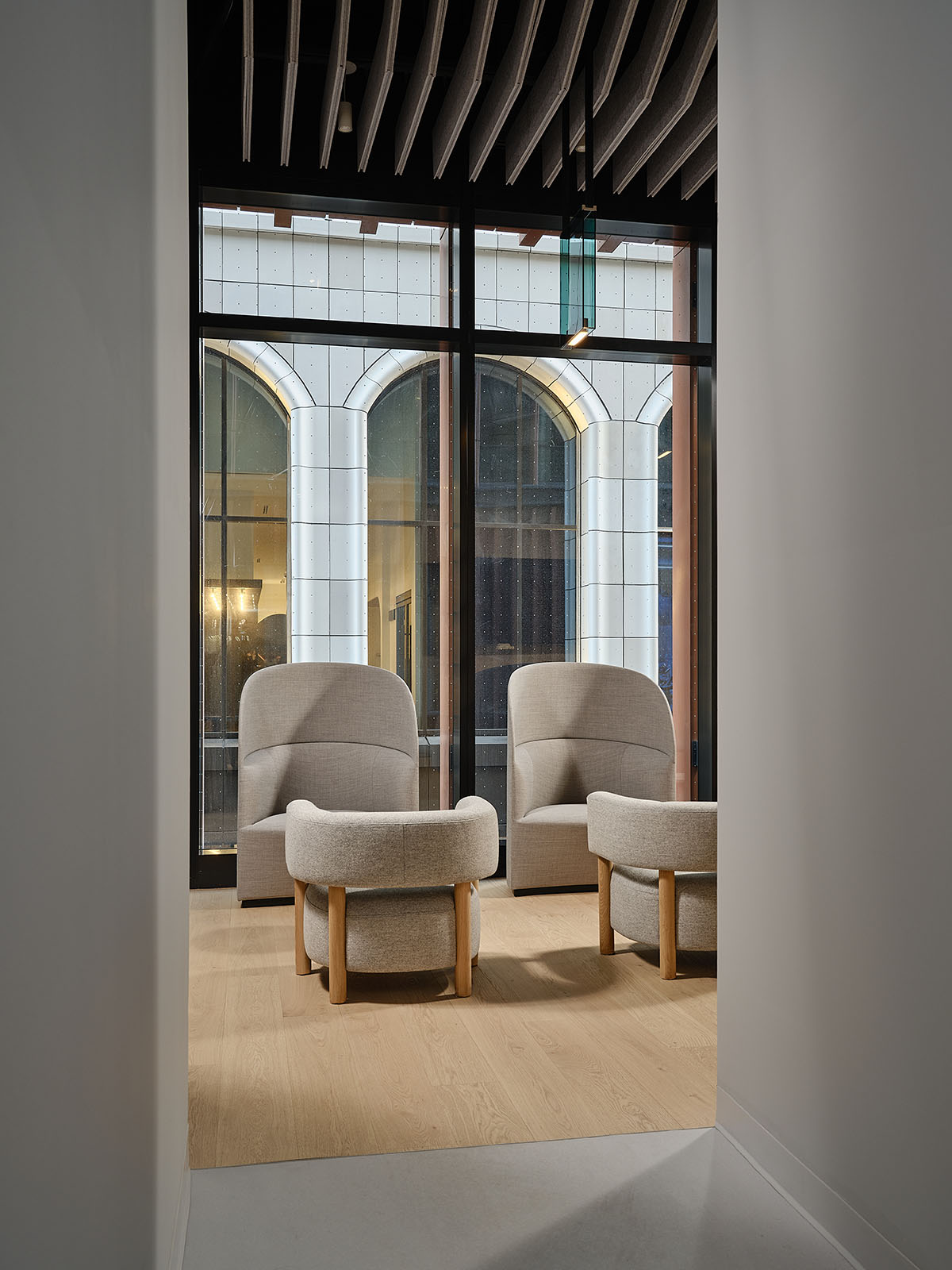 Eye care clinic features a sweeping glass block wall to disperse light in the interior