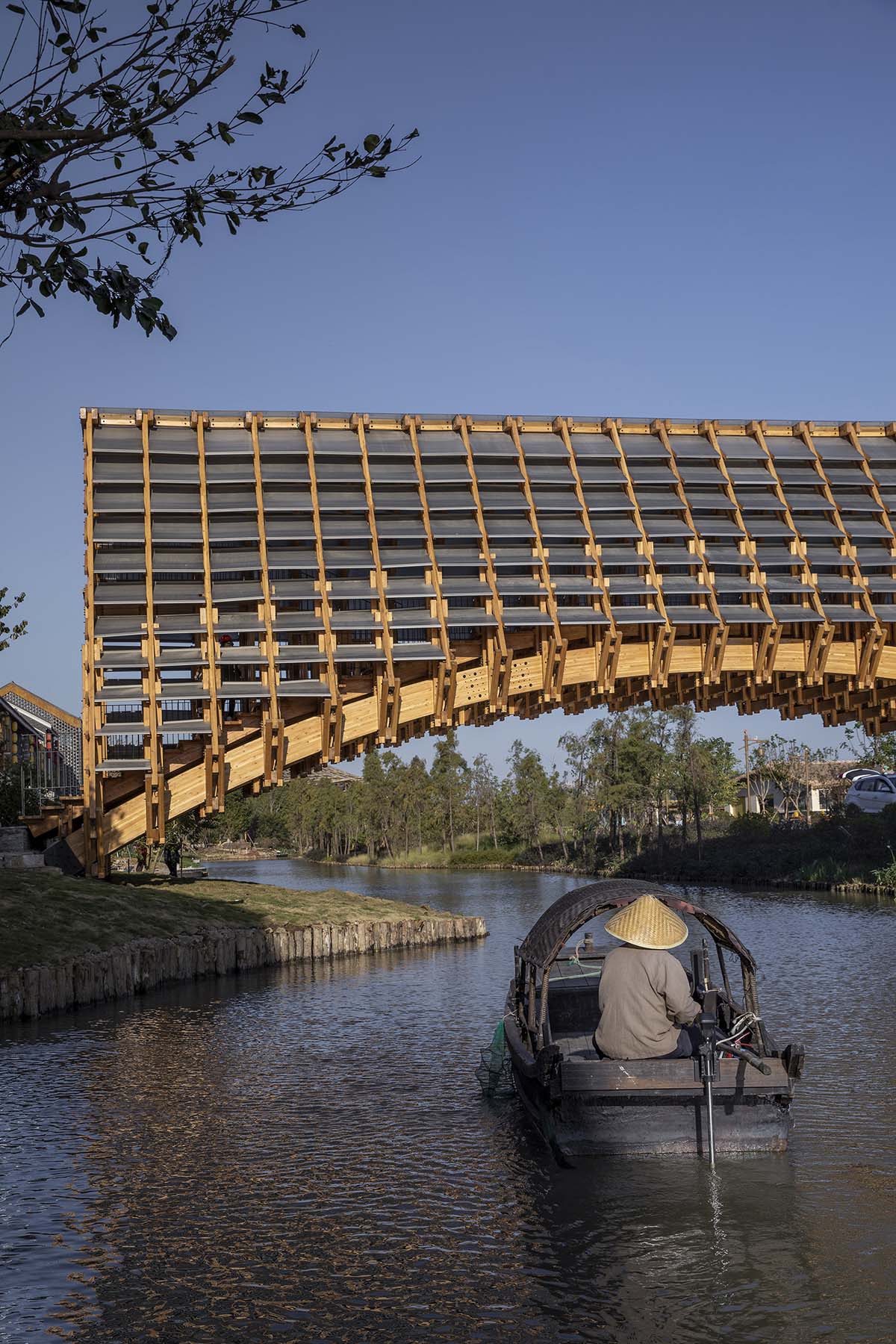 Arched timber bridge by LUO studio allows boats to pass under bridge smoothly in Gulou waterfront