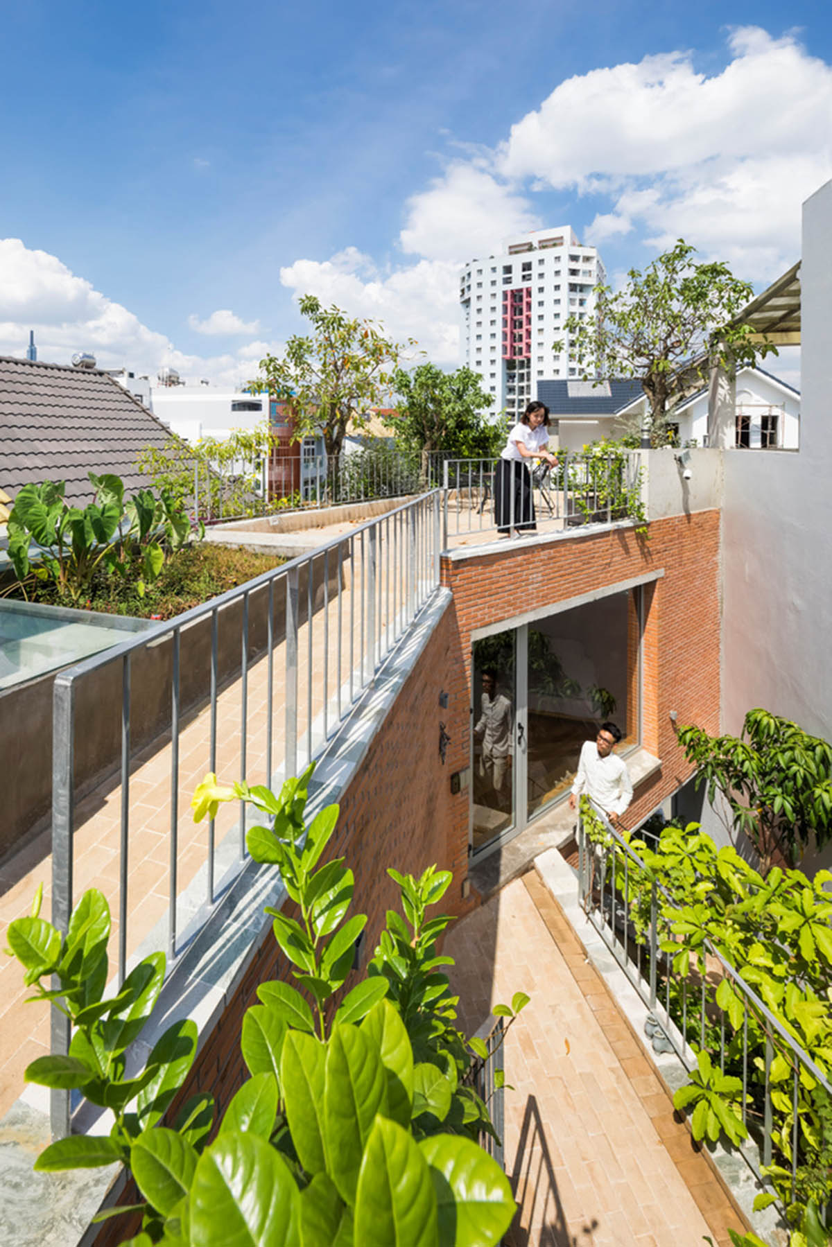 VTN Architects' new cascading family house creates large green gardens in a narrow site of Vietnam