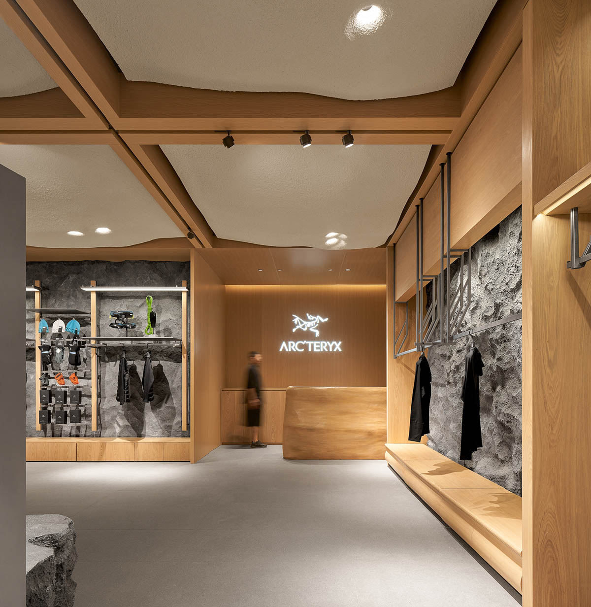 STILL YOUNG creates cave-like interiors for a store with wood and rock elements in Beijing 