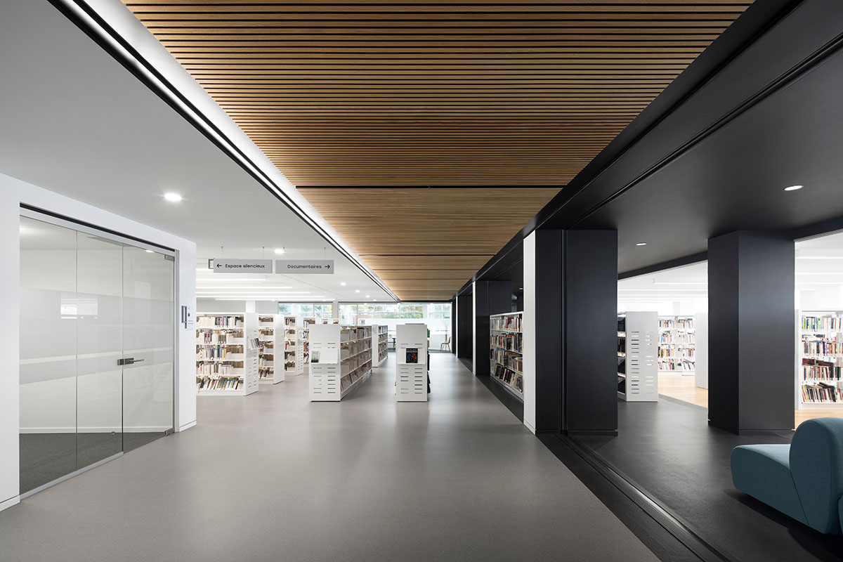 Whitish glass library designed by ACDF Architecture acts as a white floating volume in Quebec