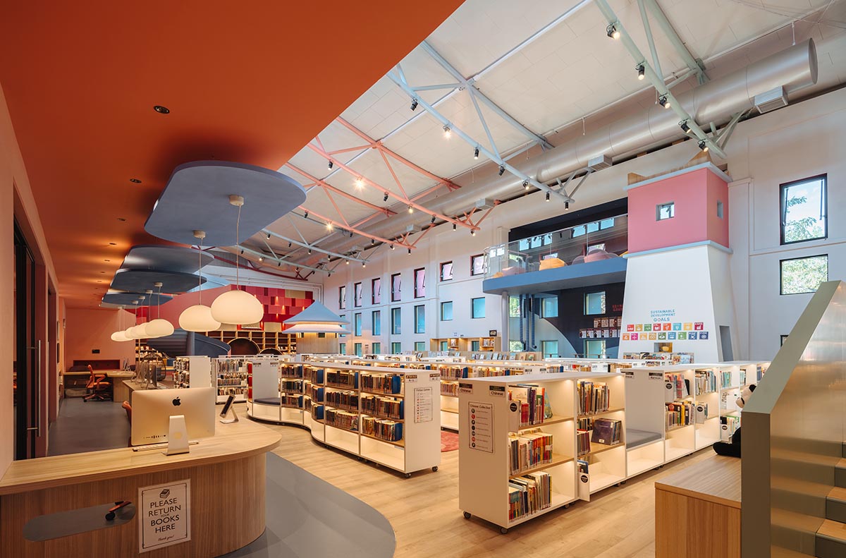 Elementary school library features vibrant colors and playful elements, resembling a fairy tale 