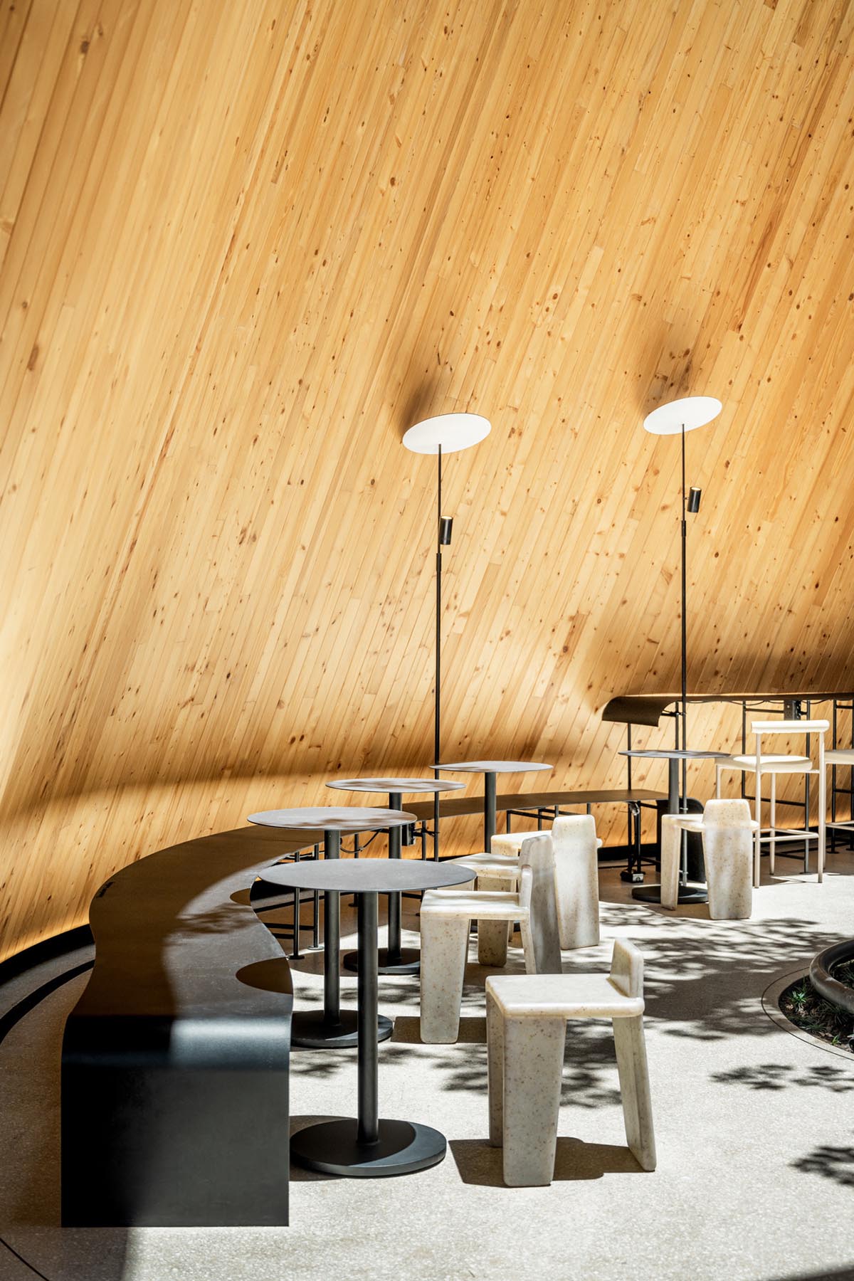 A baobab tree informs a cafe featuring three gable and fluid forms in Thailand by IDIN Architects